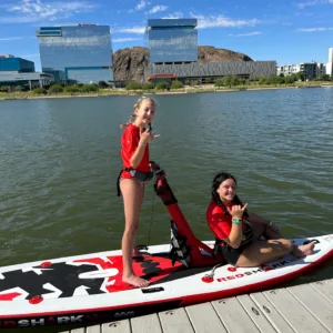 Person pedaling inflatable Red Shark water bike