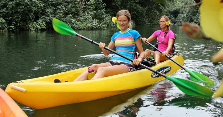 Kayak on Wailua River near lush green trees