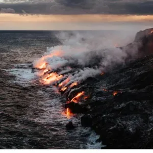 Active volcano with smoke rising from crater