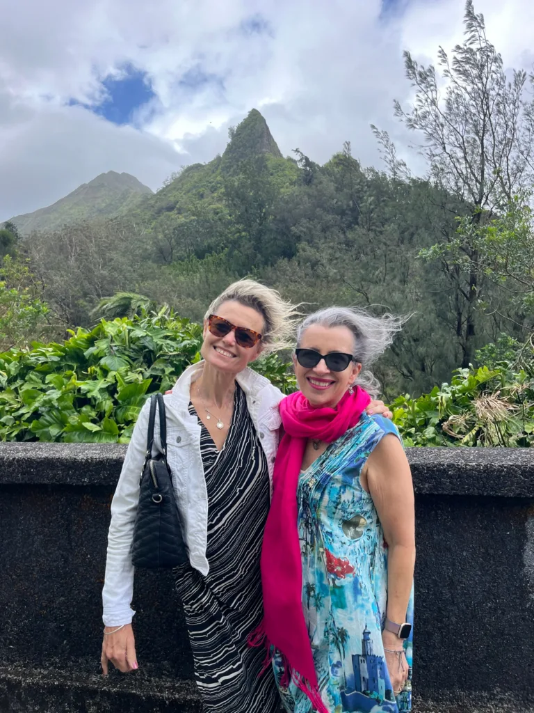 Women making fresh flower leis by the sea