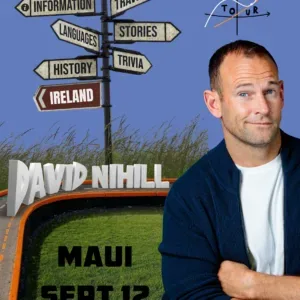 Comedian performing on stage with microphone in hand