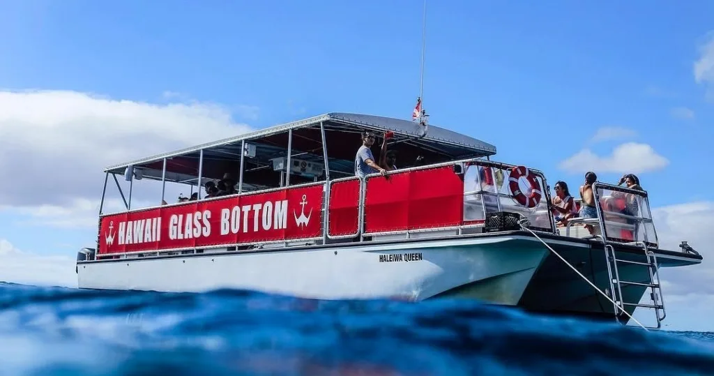 Glass bottom boat cruising over clear Hawaiian waters