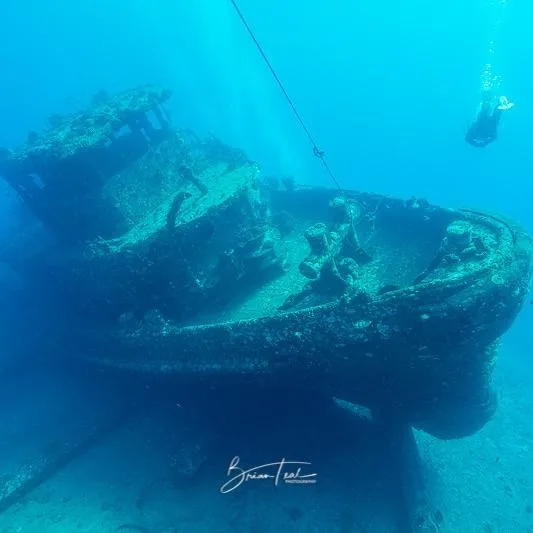 Scuba diver navigating underwater during certification dives