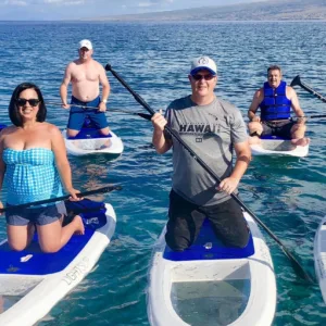 Paddlers on stand up paddleboards at sunrise