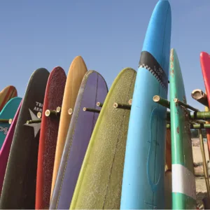 Soft top surfboard lying on a sandy beach
