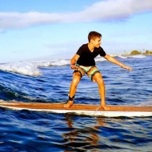 Surf instructor teaching beginner how to surf