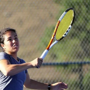 Teen tennis players competing in group training