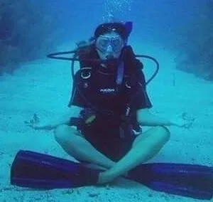 Person practicing mindful scuba meditation underwater