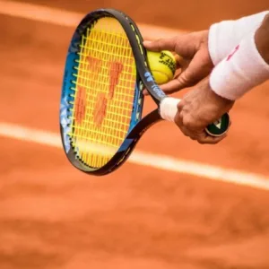 Adult tennis clinic session on outdoor court