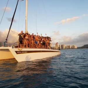 Sailboat cruising Waikiki waters at sunset