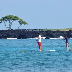 Instructor teaching stand up paddleboarding techniques