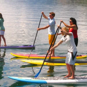 Group of people learning SUP skills together