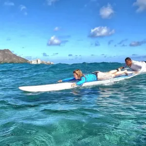 Surf instructor teaching lesson on Waikiki Beach shore