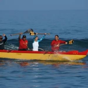 Exciting canoe surfing ride on Hawaiian waves