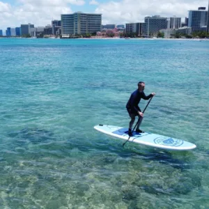 Instructor teaching stand up paddleboarding on Waikiki beach