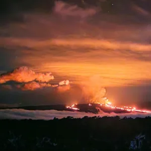Volcano erupting with glowing lava at sunset