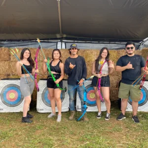 Participant aiming bow during archery lesson