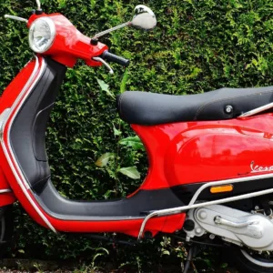 Red 50cc moped parked on Hilo street