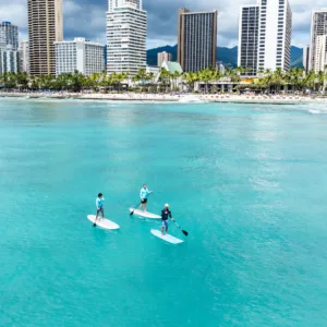 Group paddling together on stand up paddleboards in Waikiki