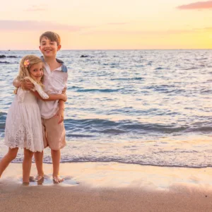 Couple posing on Waikoloa Marriott beach at sunset