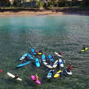 Group of beginners taking a surf lesson on the beach