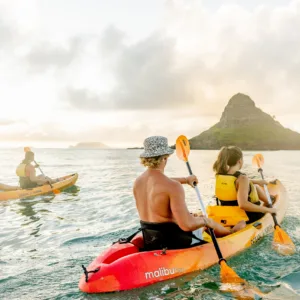 Kayakers paddling near small island