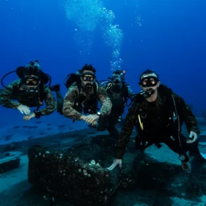 Diving club members preparing gear for boat dive