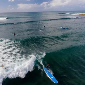 Surfer practicing skills during multi-day private surf course