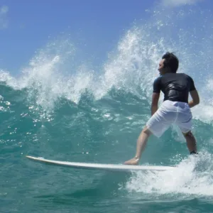 Instructor giving one-on-one surf lesson
