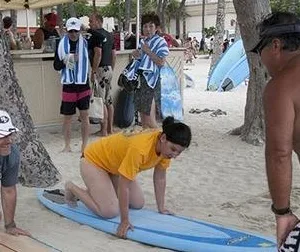 Instructor teaching surfing on Waikiki beach