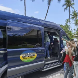 Shuttle van parked outside Kona International Airport terminal