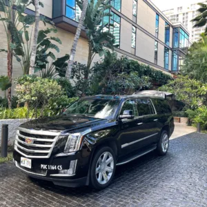 Black Escalade SUV parked outside Waikiki hotel