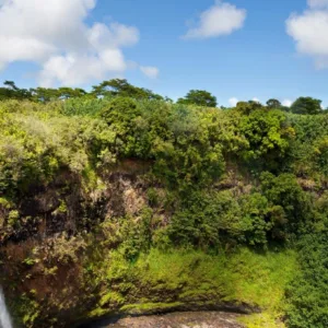 Wailua Falls cascading into a lush green valley on Kauai