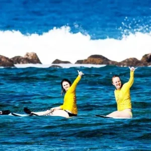 Group of surfers catching waves together
