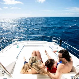 Snorkelers exploring ocean with captain and crew