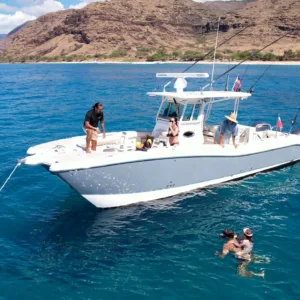 Small boat with snorkelers near ocean wildlife
