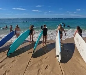 Group lesson learning to surf in Waikiki waters