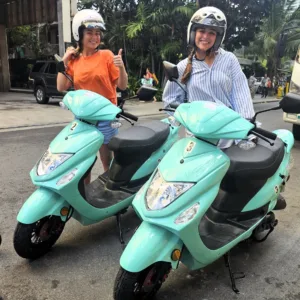 Red 50cc moped parked on Waikiki street