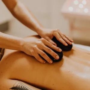 Person receiving hot stone massage