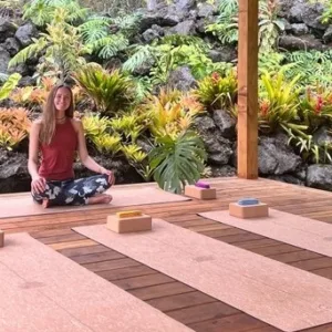 Yoga instructor leading private session in forest sanctuary