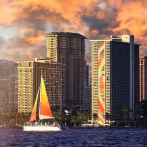 Sailboat cruising at sunset with colorful sky