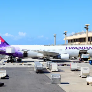 Airport shuttle van waiting outside Honolulu terminal