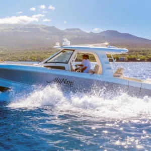 Private yacht cruising along Maui coastline at sea