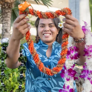 Family receiving fresh leis at Kona Airport arrival