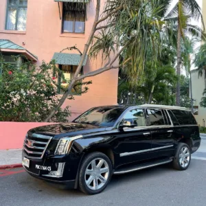 Airport shuttle van waiting outside hotel lobby