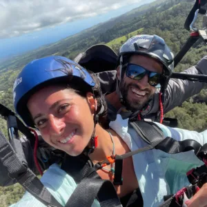 Tandem paragliding flight over Maui landscape