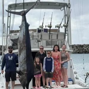 Angler holding fishing rod on sportfishing charter boat