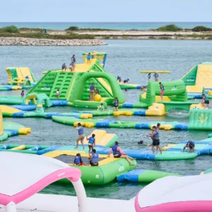 People climbing and splashing in a water adventure park