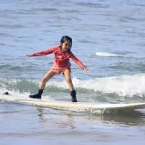 Instructor teaching surf techniques on the beach