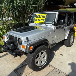 Silver vintage Jeep parked for Waikiki rental
